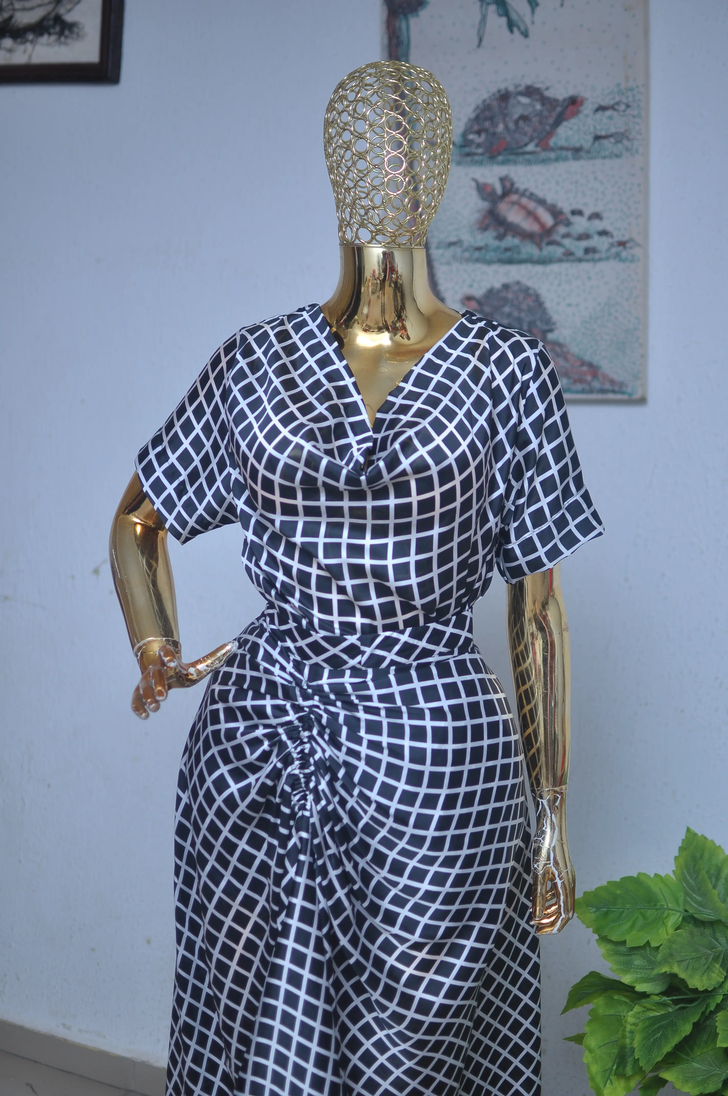 Navy and white geometric grid-print wrap dress with a cowl neckline.